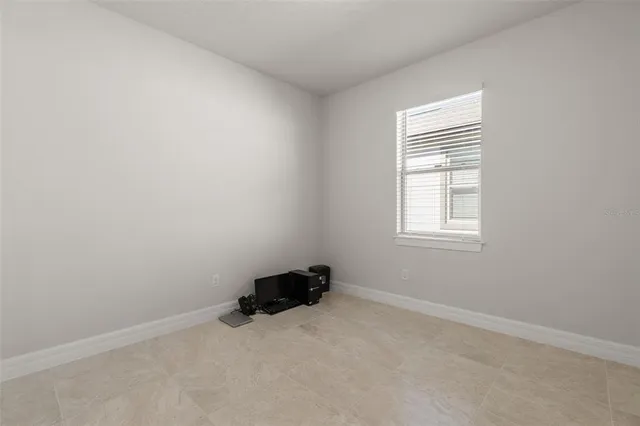 a view of an empty room and floor to ceiling window