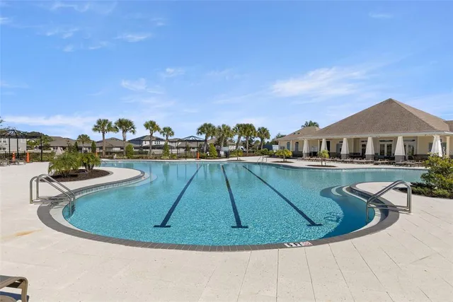 a view of a swimming pool with outdoor seating