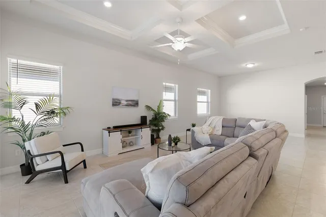 a living room with furniture and a chandelier