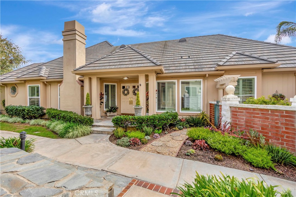 front view of a house with potted plants