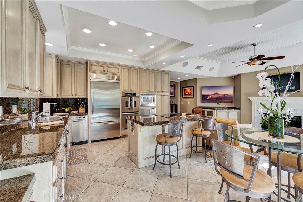 6096 Eaglecrest Drive Huntington Beach, CA 92648 - Photo 19 of 64 a kitchen with refrigerator and chairs