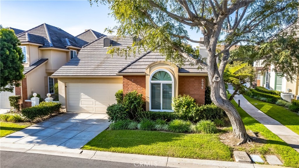 6096 Eaglecrest Drive Huntington Beach, CA 92648 - Photo 2 of 64 a front view of a house with a garden and trees