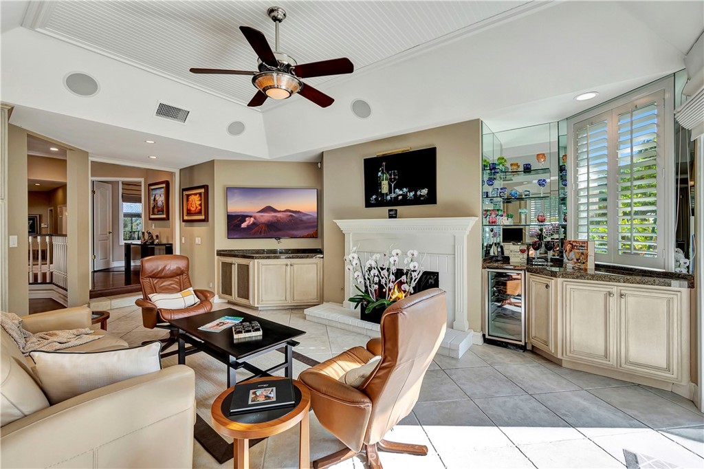 6096 Eaglecrest Drive Huntington Beach, CA 92648 - Photo 23 of 64 a living room with furniture a flat screen tv and a window