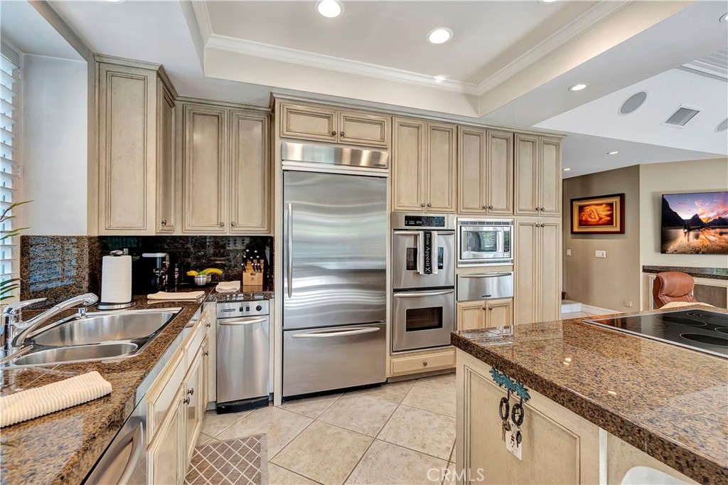 6096 Eaglecrest Drive Huntington Beach, CA 92648 - Photo 25 of 64 a kitchen with granite countertop a sink stainless steel appliances and cabinets