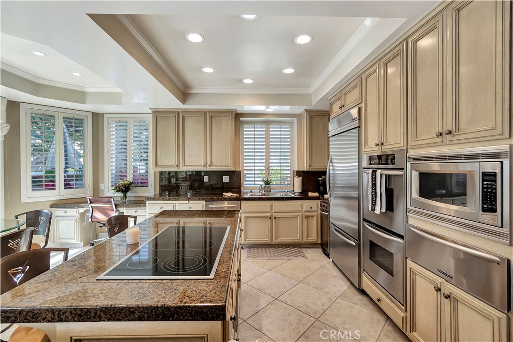 6096 Eaglecrest Drive Huntington Beach, CA 92648 - Photo 27 of 64 a kitchen with stainless steel appliances granite countertop a stove a sink and a microwave
