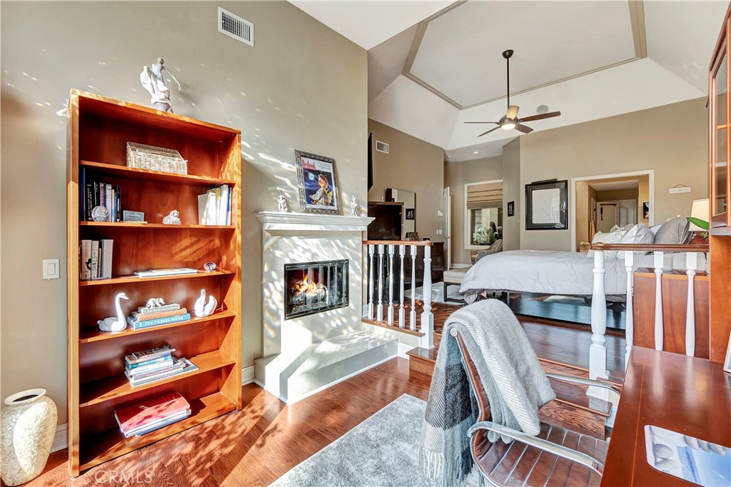 6096 Eaglecrest Drive Huntington Beach, CA 92648 - Photo 32 of 64 a living room with furniture a flat screen tv and a fireplace