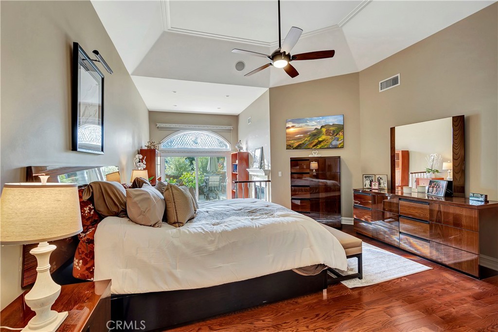6096 Eaglecrest Drive Huntington Beach, CA 92648 - Photo 33 of 64 a bedroom with a large bed and a flat tv screen on dresser