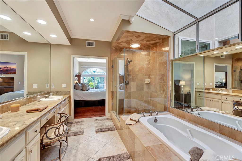 6096 Eaglecrest Drive Huntington Beach, CA 92648 - Photo 37 of 64 a spacious bathroom with a double vanity sink a large mirror and shower