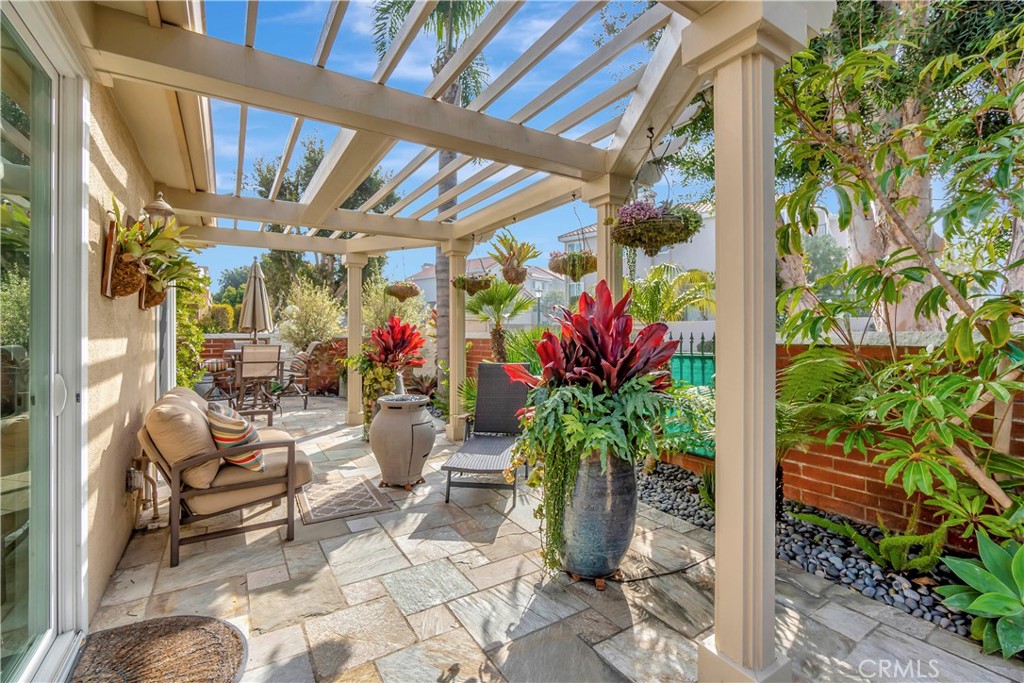 6096 Eaglecrest Drive Huntington Beach, CA 92648 - Photo 49 of 64 a view of a porch with chairs and potted plants