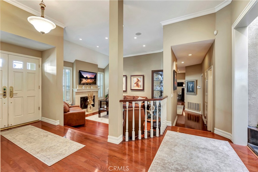 6096 Eaglecrest Drive Huntington Beach, CA 92648 - Photo 5 of 64 a living room with furniture a rug and a chandelier