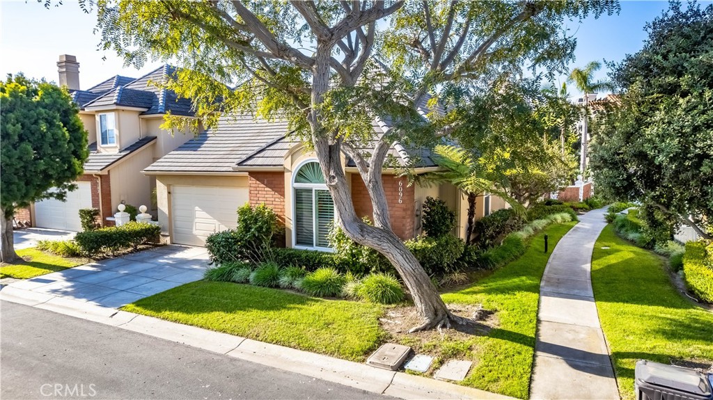 6096 Eaglecrest Drive Huntington Beach, CA 92648 - Photo 52 of 64 a view of yellow house with swimming pool lawn chairs and plants