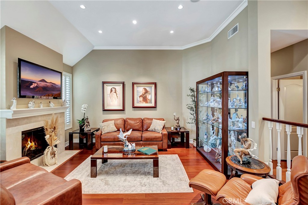 6096 Eaglecrest Drive Huntington Beach, CA 92648 - Photo 7 of 64 a living room with furniture a fireplace and a flat screen tv