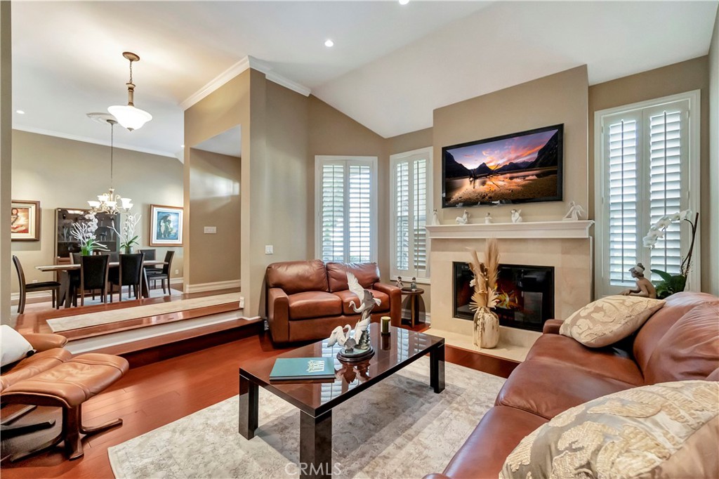 6096 Eaglecrest Drive Huntington Beach, CA 92648 - Photo 8 of 64 a living room with furniture a flat screen tv and a fireplace