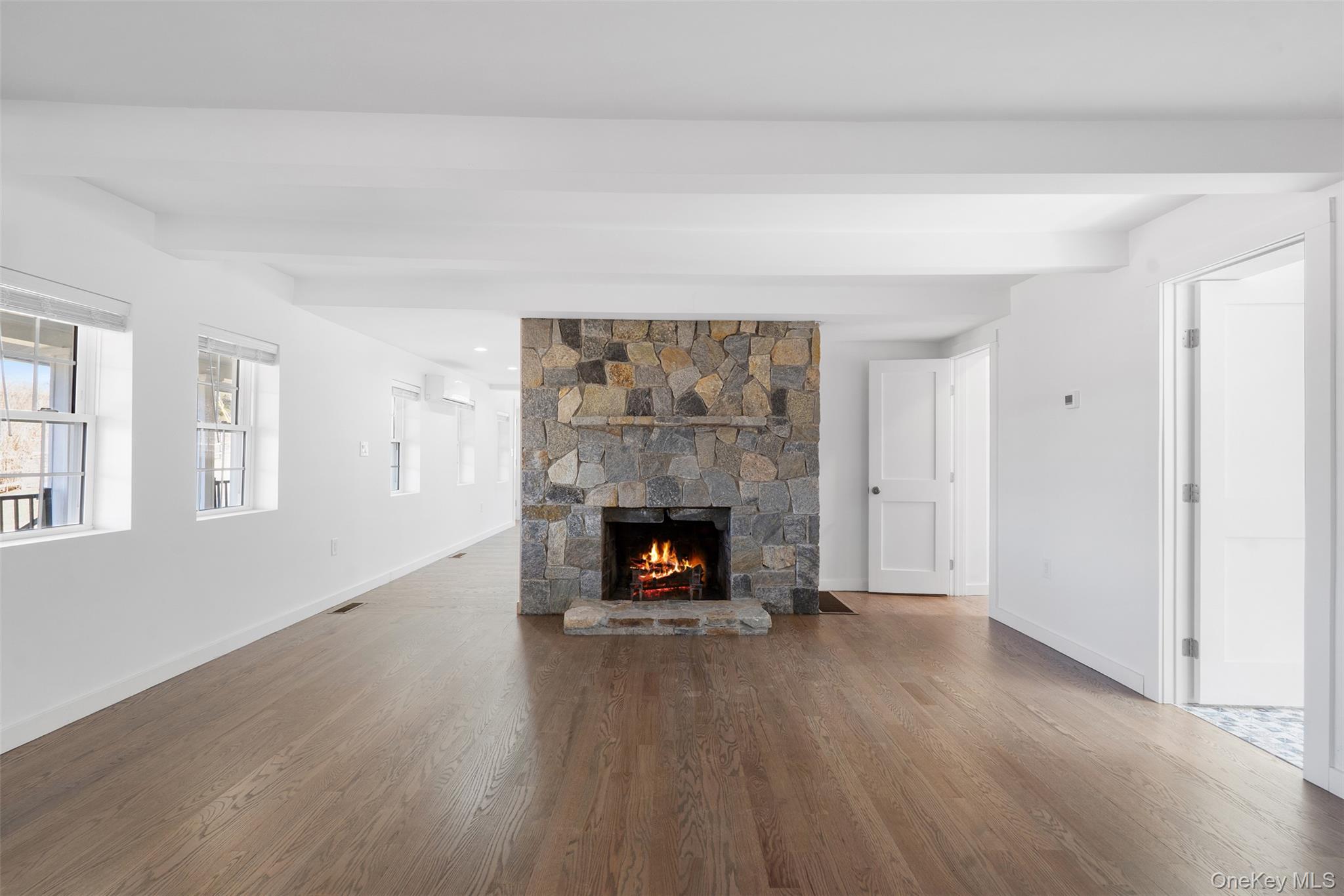 70 Barmore Road LaGrangeville, NY 12540 - Photo 13 of 47 Unfurnished living room with healthy amount of natural light, wood finished floors, and a fireplace