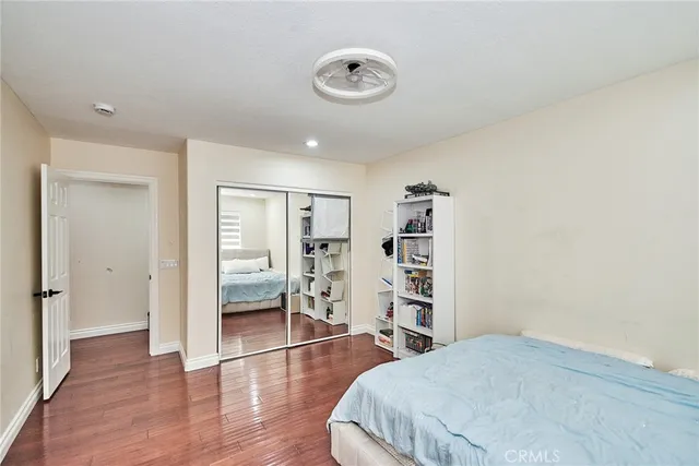 a bedroom with a bed and a book shelf