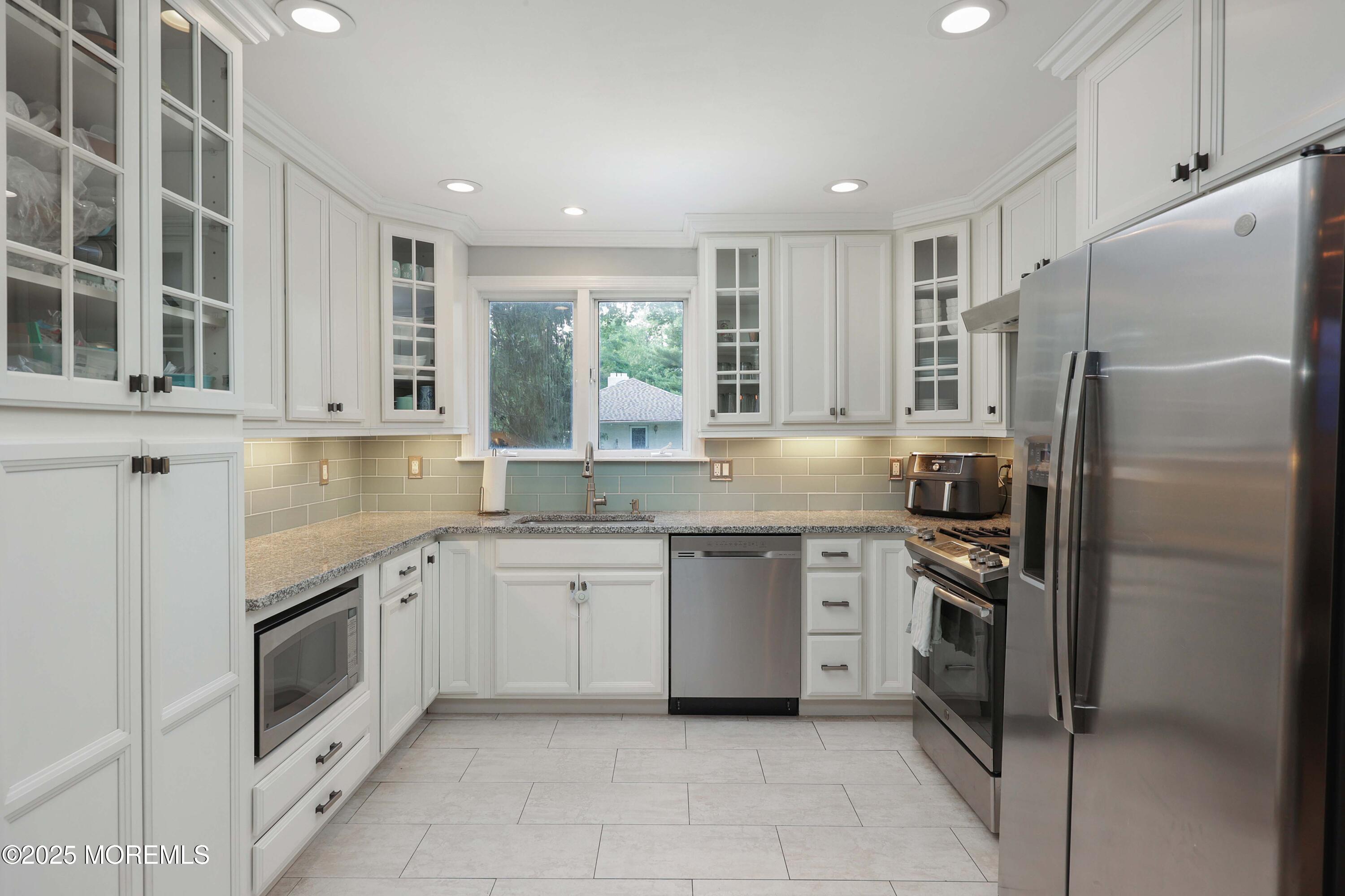 29 Lake Boulevard Matawan, NJ 07747 - Photo 12 of 39 a kitchen with granite countertop stainless steel appliances and white cabinets