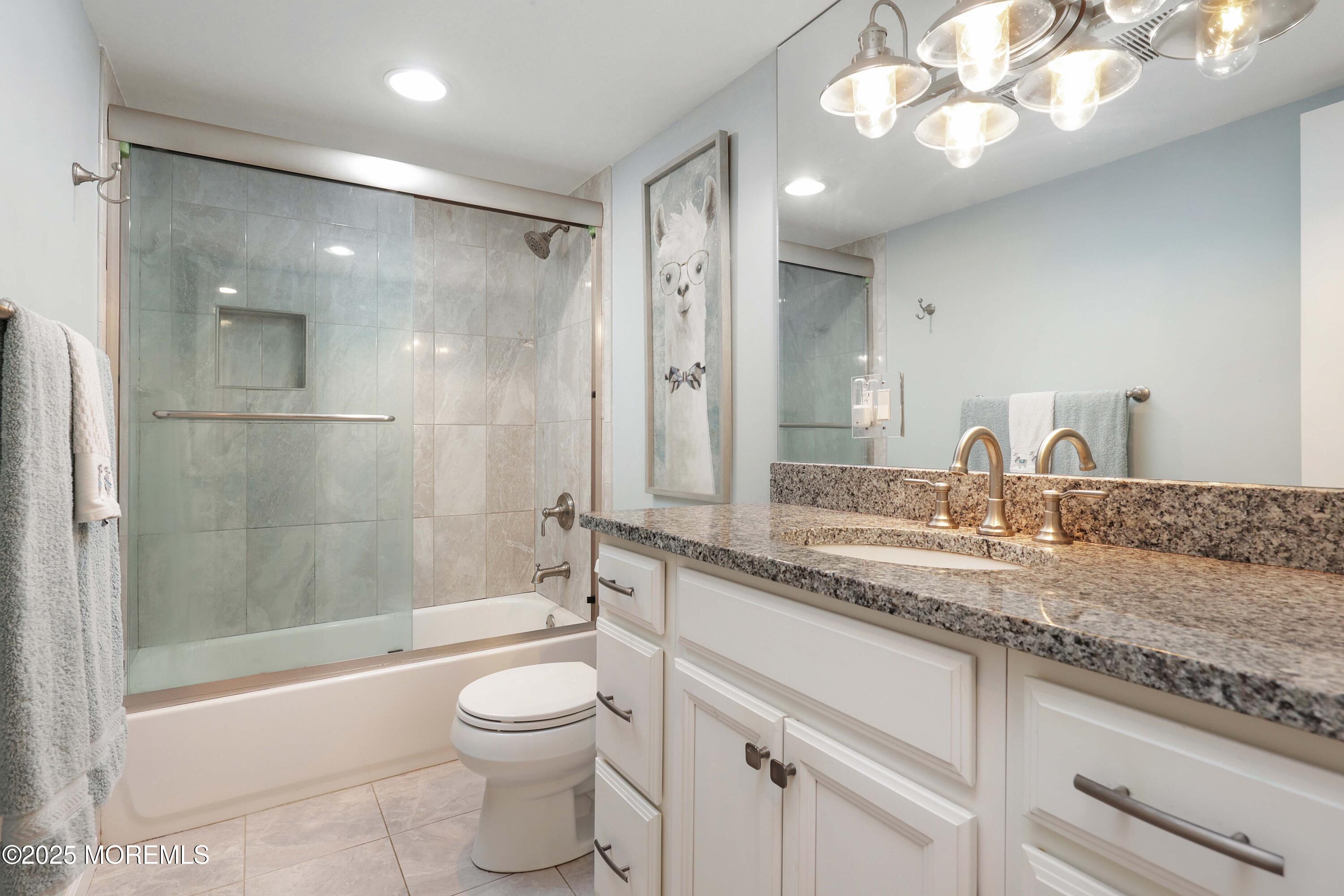 29 Lake Boulevard Matawan, NJ 07747 - Photo 22 of 39 a bathroom with a granite countertop sink a toilet and shower