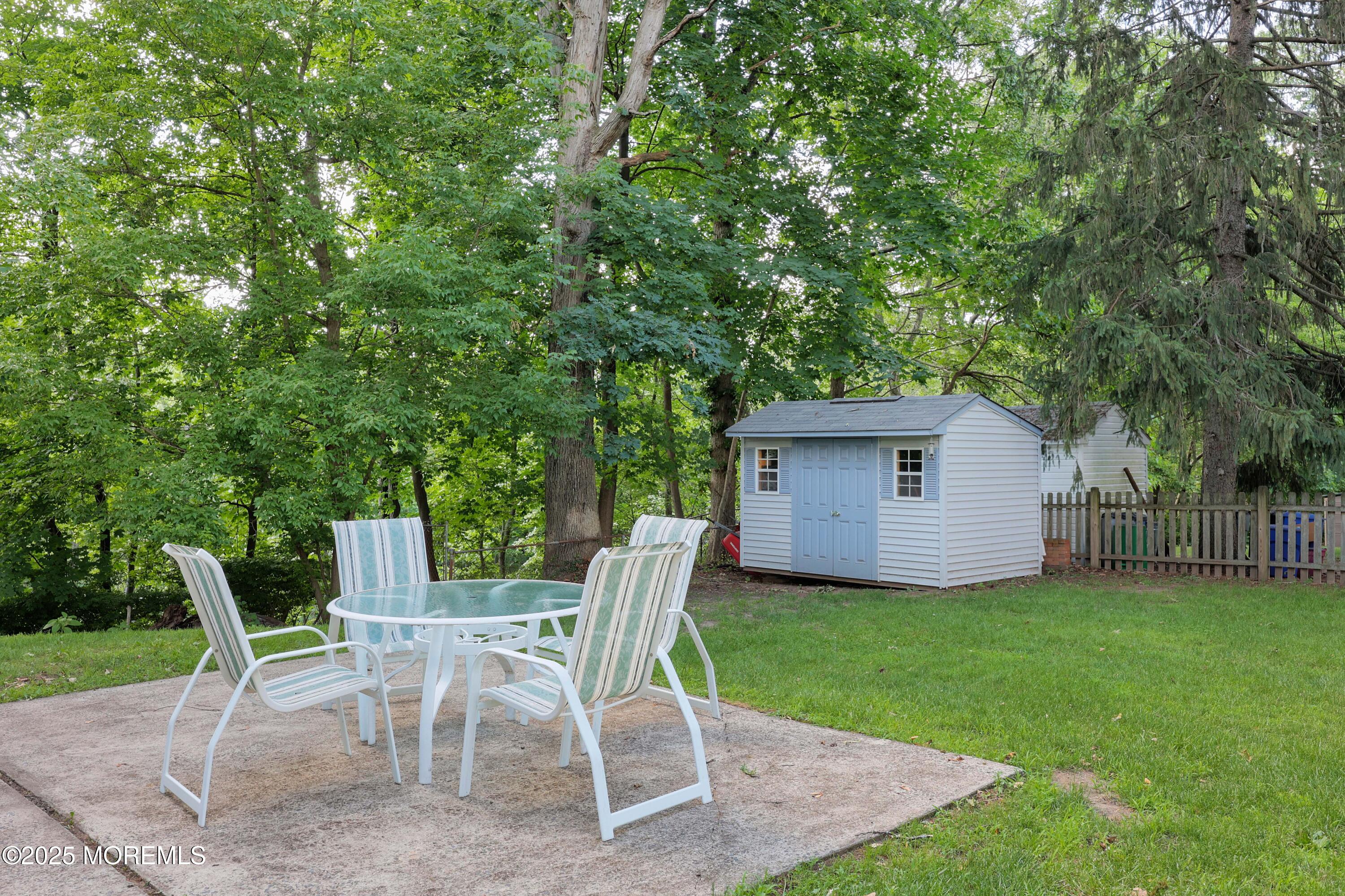 29 Lake Boulevard Matawan, NJ 07747 - Photo 29 of 39 a view of a chairs and table in backyard
