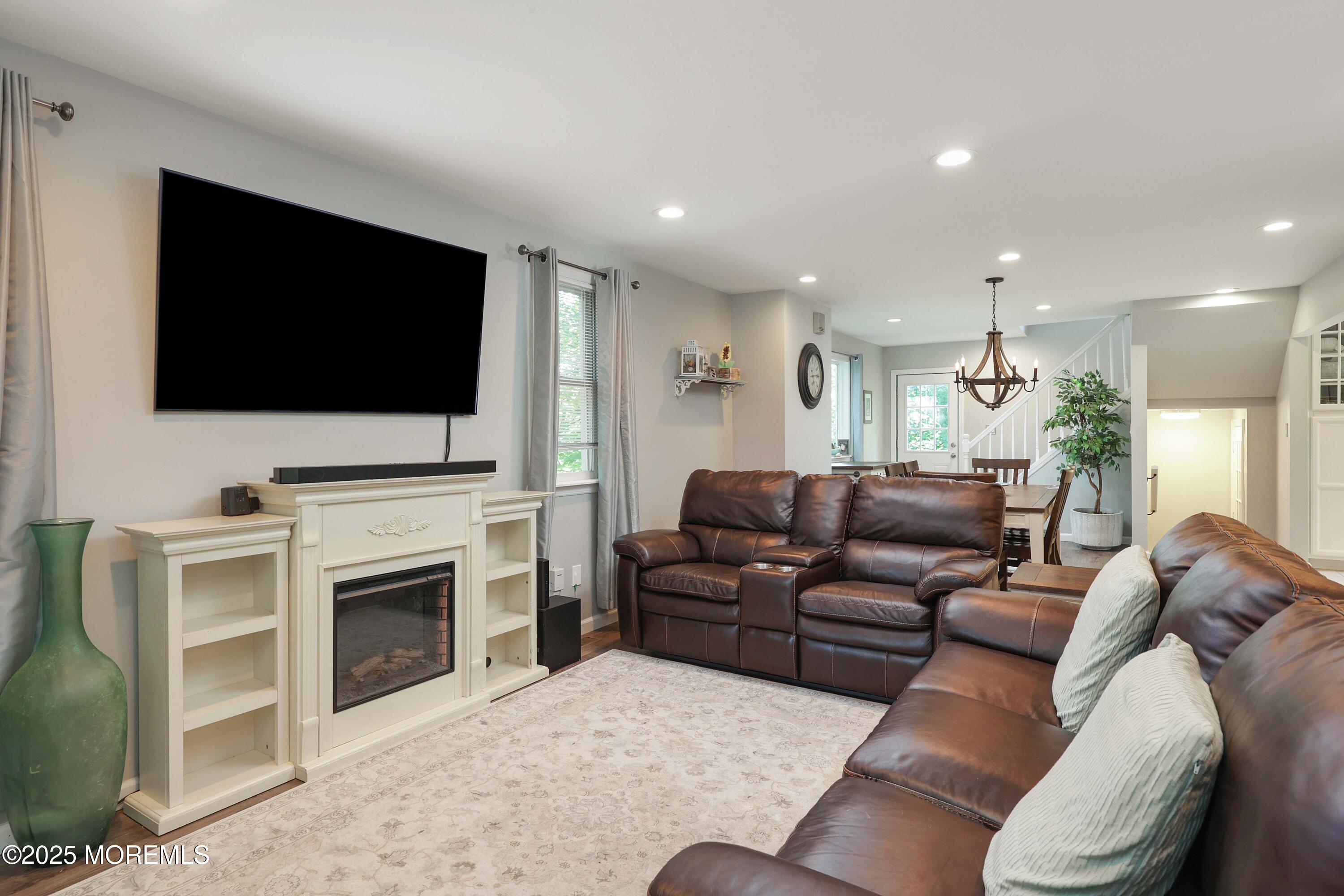 29 Lake Boulevard Matawan, NJ 07747 - Photo 7 of 39 a living room with furniture a fireplace and a flat screen tv