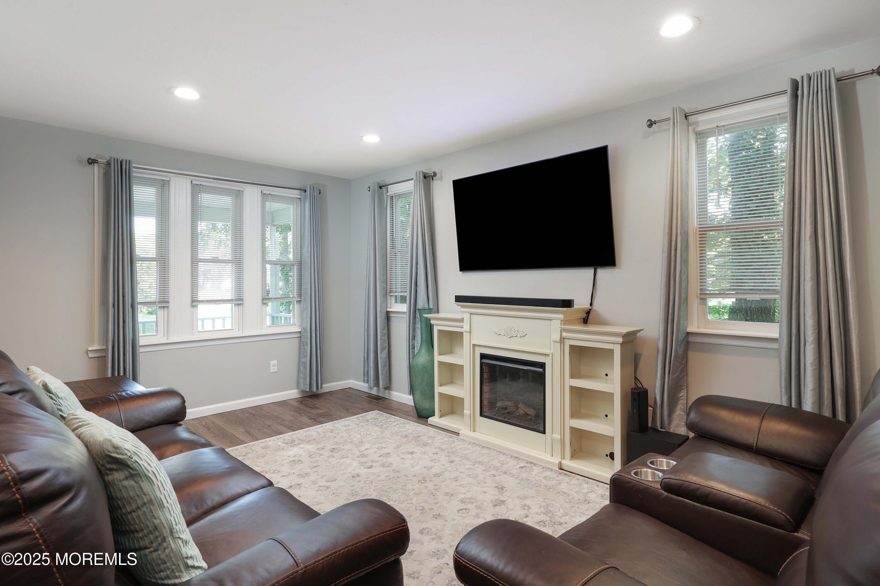 29 Lake Boulevard Matawan, NJ 07747 - Photo 8 of 39 a living room with furniture a flat screen tv and a fireplace