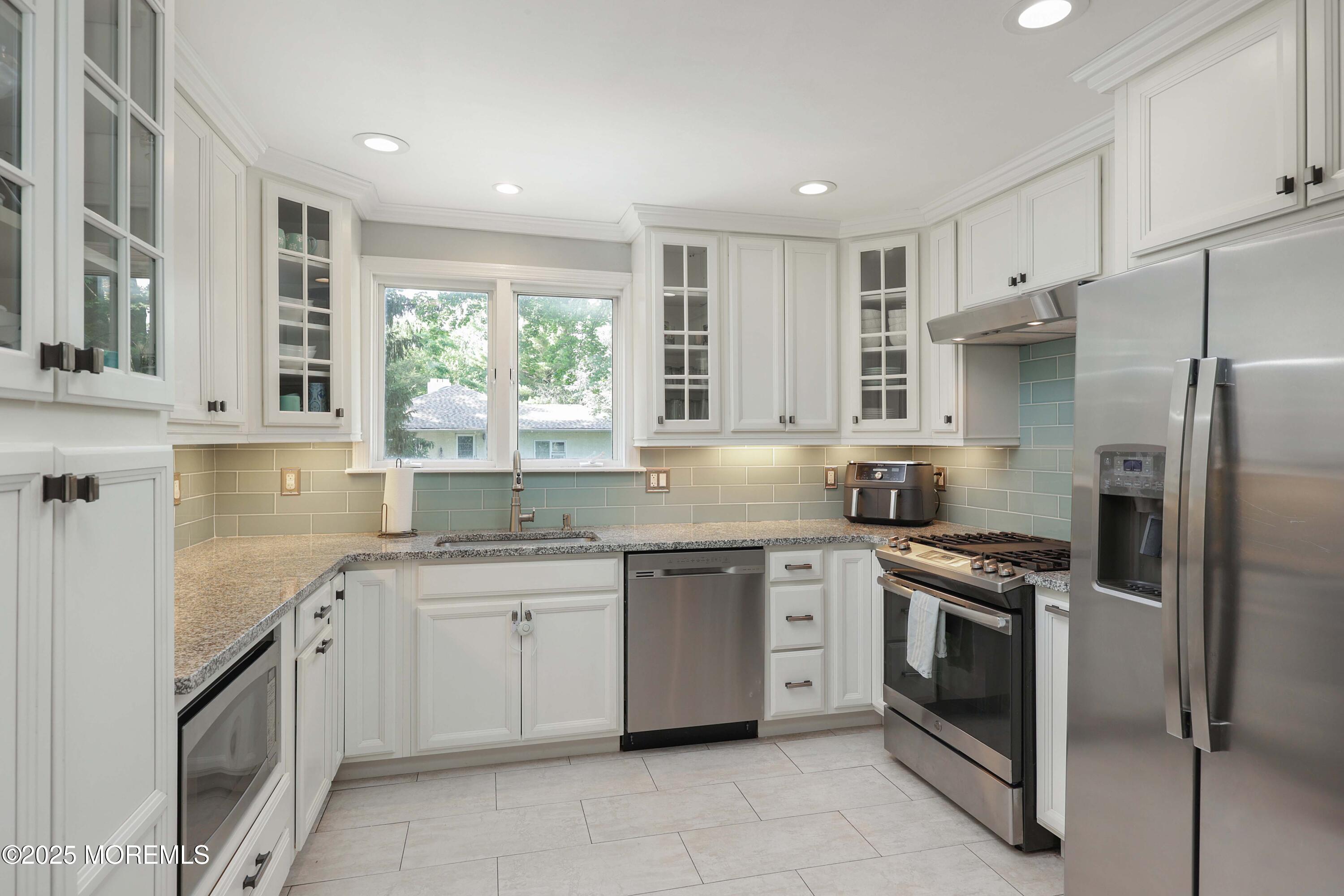 29 Lake Boulevard Matawan, NJ 07747 - Photo 10 of 39 a kitchen with a sink stove and refrigerator