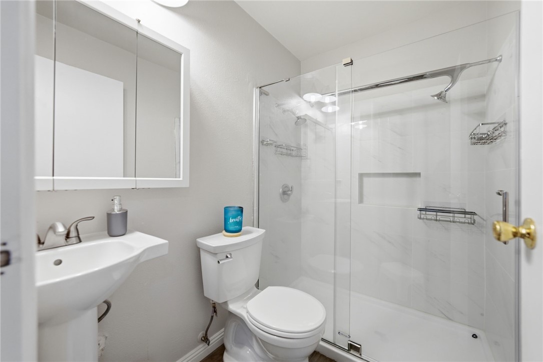 4869 Serrano Place Riverside, CA 92504 - Photo 31 of 40 Modern bathroom featuring a sleek glass-enclosed shower, clean finishes, and a bright, refreshed design.