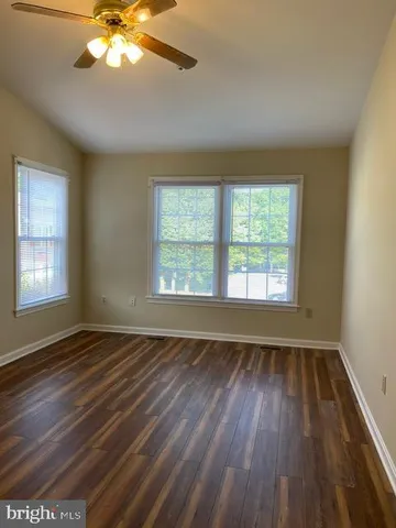 a view of an empty room and wooden floor