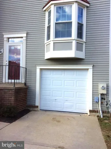 a view of a house with parking space and windows