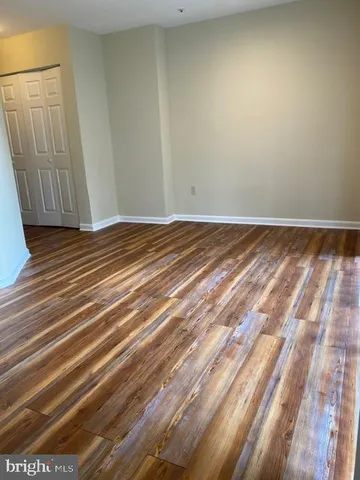 a view of a room with wooden floor and large windows