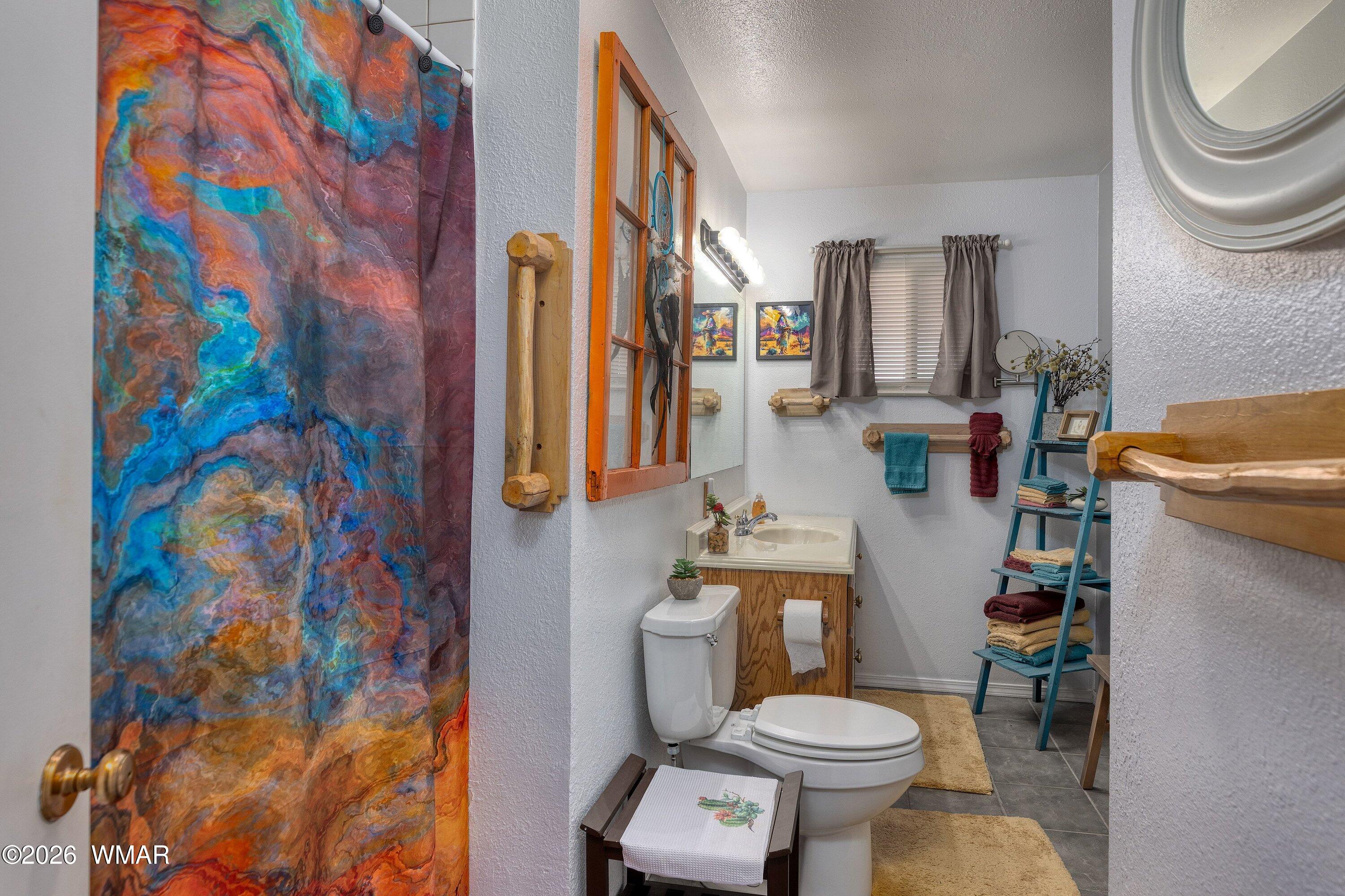 1114 Ranch Road Taylor, AZ 85939 - Photo 21 of 32 a white toilet sitting next to a bathroom sink