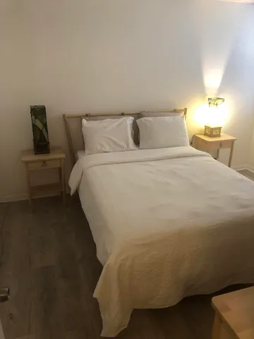 a bedroom with a bed and night stand