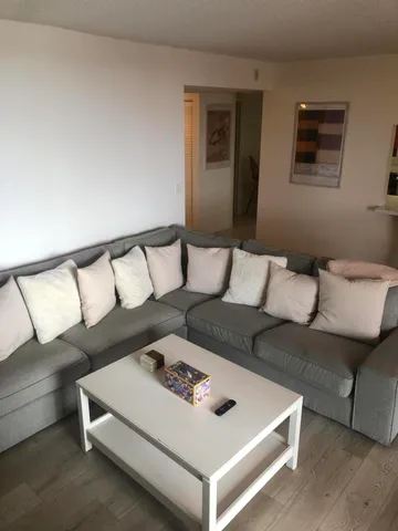 a living room with furniture and a night stand