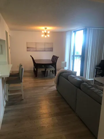a living room with furniture and a dining table