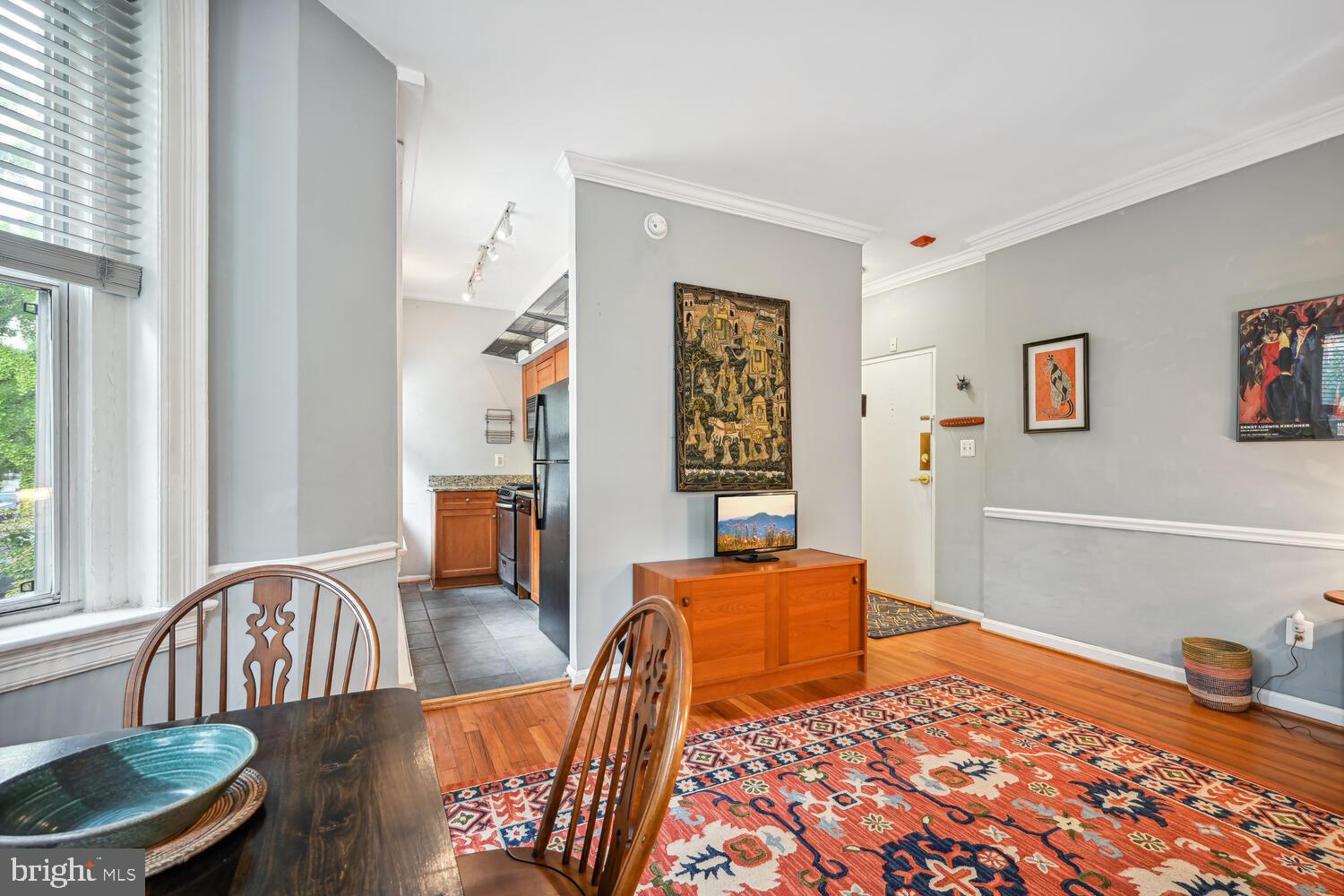 1831 Belmont Road Northwest, Unit 201 Washington, DC 20009 - Photo 6 of 11 a bedroom with furniture and wooden floor