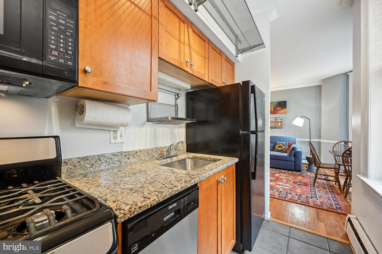 1831 Belmont Road Northwest, Unit 201 Washington, DC 20009 - Photo 8 of 11 a kitchen with a stove and a refrigerator