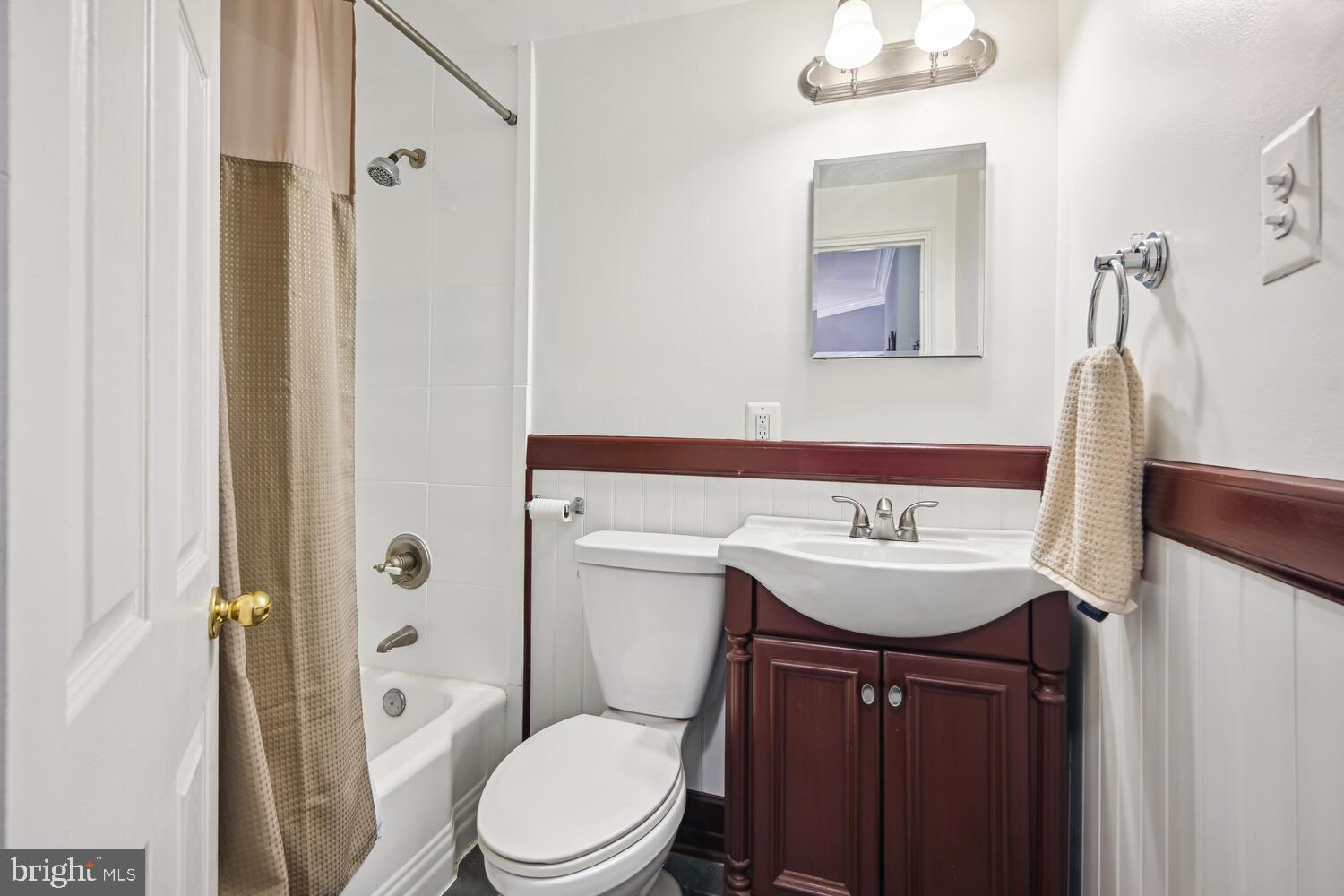 1831 Belmont Road Northwest, Unit 201 Washington, DC 20009 - Photo 9 of 11 a bathroom with a sink a toilet and shower