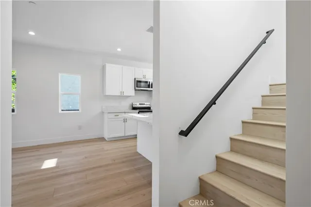 a view of kitchen with wooden floor and electronic appliances