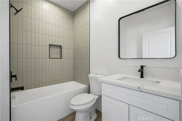 a bathroom with a sink a toilet and bathtub