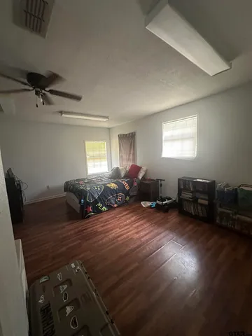 a bed room with furniture and gym equipment