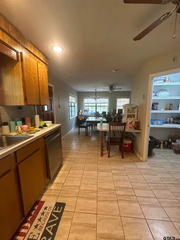 a kitchen with lots of counter top space and furniture