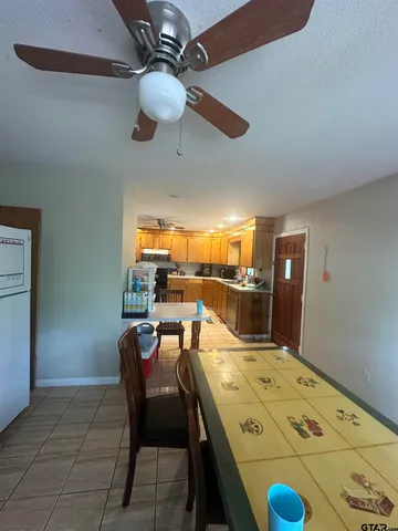 a kitchen with a table chairs and a refrigerator