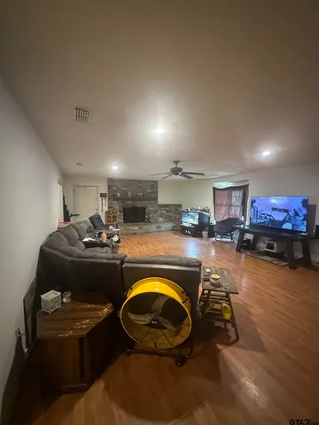 a room with wooden furniture and kitchen view