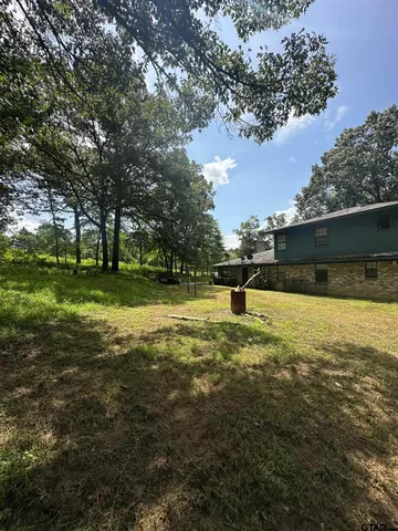 a backyard of a house with lots of green space