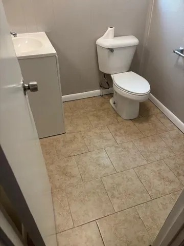 a white toilet sitting next to a bathroom sink