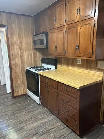 a kitchen with stainless steel appliances granite countertop a sink and a stove
