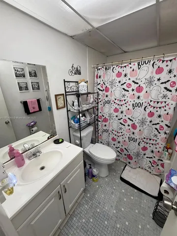 a bathroom with a sink toilet and a shower