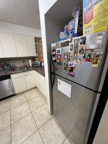 a kitchen with stainless steel appliances granite countertop a refrigerator and a stove