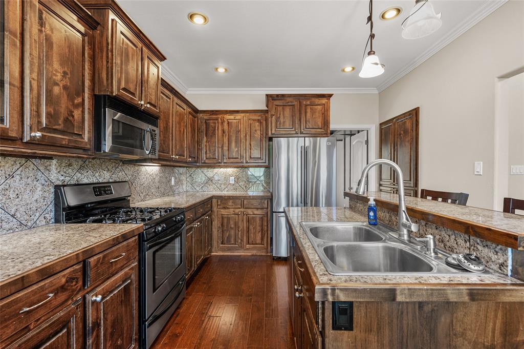 10264 Farmington Road Van Alstyne, TX 75495 - Photo 13 of 39 a kitchen that has a sink and a stove