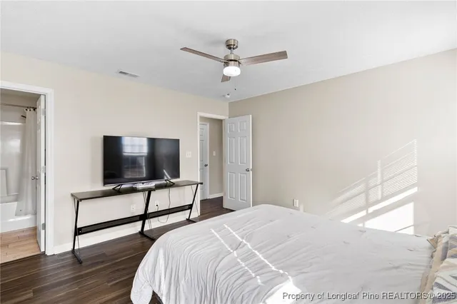 a bedroom with bed and tv