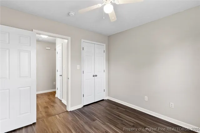 a view of an empty room with wooden floor